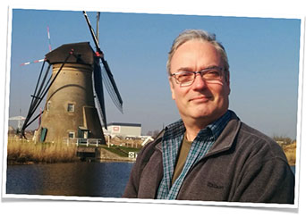 Photo of Andrew Foster near a windmill
