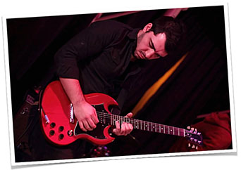 Photo of Jose Batista playing guitar